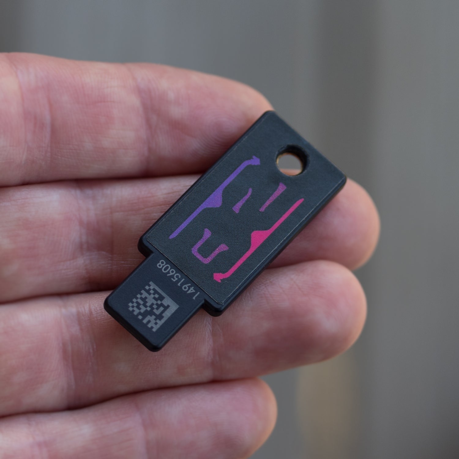 Dark side of the DEF CON 32 YubiStyle covered YubiKey in hand