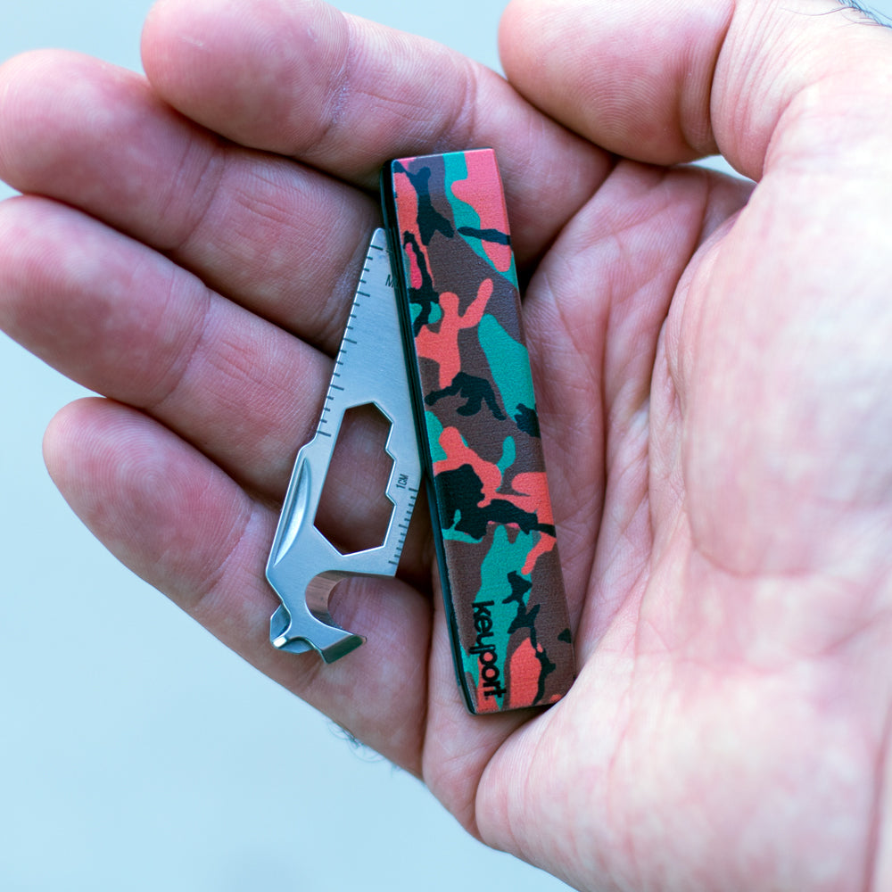 Keyport Faceplate with an orange camouflage pattern in hand