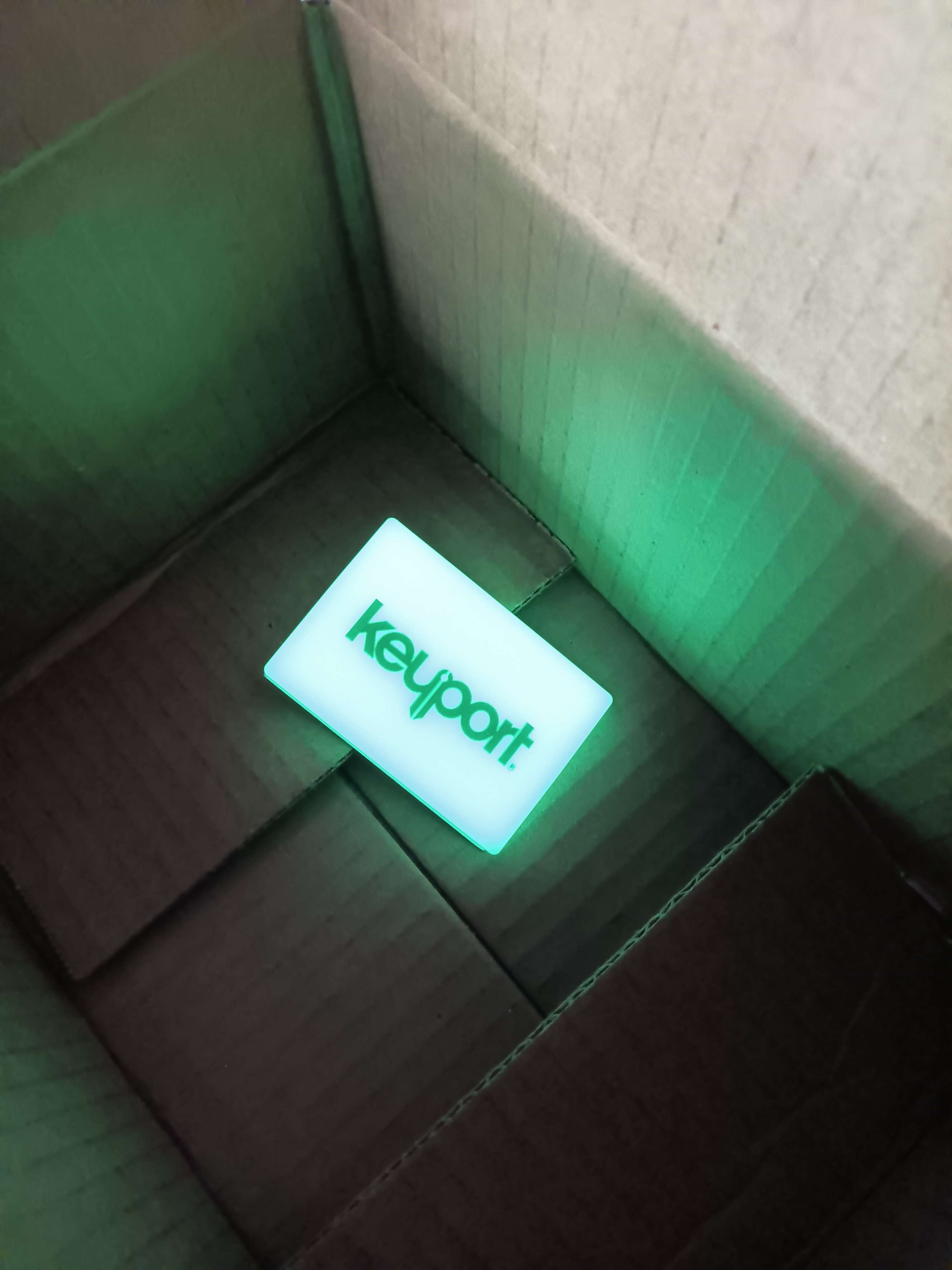 Green Keyport Embrite Glow Patch lighting up a cardboard box